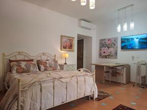 a bedroom with a bed and a desk in it at Villa Margot in Agropoli +193 photos