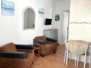 a living room with leather furniture and a table at Casa Maena in Cómpeta