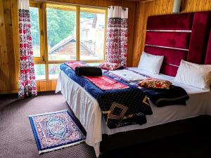 a bedroom with a bed with blankets and a window at Hotel alpine resort pahalgam in Pahalgām +24 photos