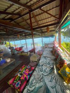 a large room with many pillows on the floor at On the Rocks in Koh Rong Sanloem +53 photos