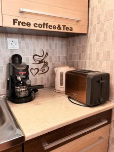 a kitchen counter with a coffee maker and a toaster at CENTRUM Apartman in Sárospatak +7 photos