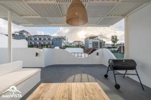 a room with white walls and a table and a chair at Villa Luminosa 3 by Bukit Vista in Uluwatu