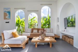 a living room with two couches and a coffee table at Villa Luminosa 3 by Bukit Vista in Uluwatu