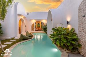 a swimming pool in the middle of a house at Villa Luminosa 3 by Bukit Vista in Uluwatu