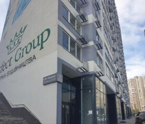 a building with a sign on the side of it at Супер Видові апартаменти метро Позняки Харківська in Kyiv