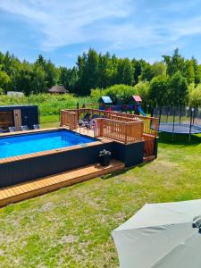 a backyard with a pool and a playground at Antracytowy Zakątek in Łeba