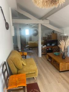 a living room with a couch and a table at Appartement in Arles