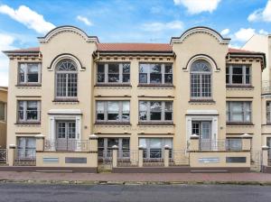 a large building with windows and balconies on a street at Manly Waterfront Apartment Harbourside in Sydney