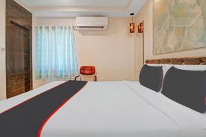 a bedroom with a large white bed and a window at Super Collection O Halcyon SS Grand in Hyderabad