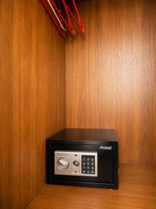 a black microwave sitting on top of a wooden wall at Kalias Hotel in Vasiliki
