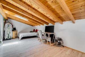 a room with wooden ceilings and a table and chairs at OKU Country Loft in Monchique
