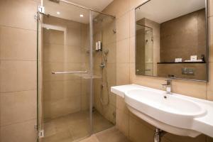 a bathroom with a sink and a shower at Hotel Star City in Chennai