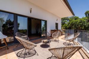 a group of chairs and tables on a patio at OKU Country Loft in Monchique