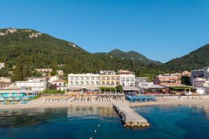 a view of a beach with chairs and a resort at Aeloria Boutique Hotel Corfu in Benitses