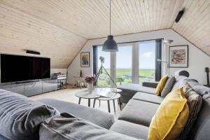 a living room with a couch and a tv at 8997-Orsted-Rougsovej-326-B in Ørsted