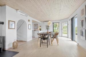 a dining room with a table and chairs at 8997-Orsted-Rougsovej-326-B in Ørsted