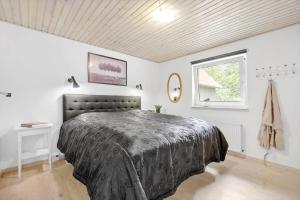 a bedroom with a bed and a window at 8997-Orsted-Rougsovej-326-B in Ørsted