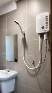 a shower in a bathroom with a sink and a mirror at Lucky Hostel in Vientiane