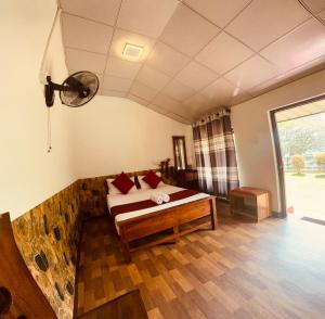 a bedroom with a bed with red pillows on it at Lake Classical Guest House in Kandy