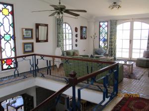 a living room with a staircase and stained glass windows at Le Refuge in Larache +4 photos