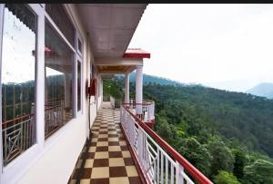 a balcony of a house with a checkered floor at THE PINE STAy in Chail