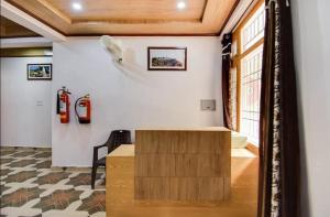 a room with a desk and fire extinguishers on the wall at THE PINE STAy in Chail