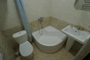 a bathroom with a toilet and a sink at Hotel Ayyub Sultan in Urganch