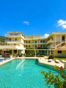 a large swimming pool in front of a building at Kalias Hotel in Vasiliki