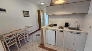 a kitchen with a sink and a counter top at Luna di mare 2 Igalo in Igalo