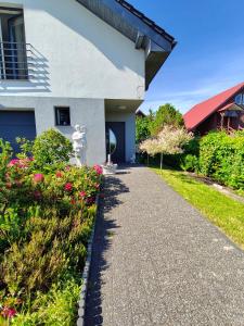 a walkway in front of a house with flowers at Brzask in Mosty