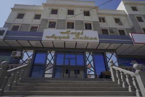 a building with a sign that reads hotel august at Hotel Ayyub Sultan in Urganch