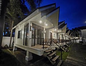 a house with stairs leading up to it at night at Cleon Villas Pension in Puerto Princesa City