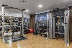 a gym with several treadmills and weights at Hotel Aateli Lakeside in Vuokatti