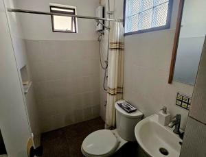 a small bathroom with a toilet and a sink at Cleon Villas Pension in Puerto Princesa City