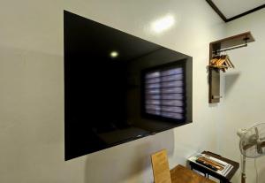 a large flat screen tv on a wall at Cleon Villas Pension in Puerto Princesa City