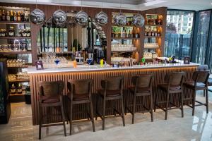 a bar in a restaurant with chairs around it at Adenz Otel in Elmadağ