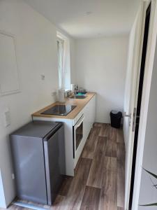 a small kitchen with a sink and a counter at Monteurswohnungen - Klein Wanzleben in Klein Wanzleben +20 photos