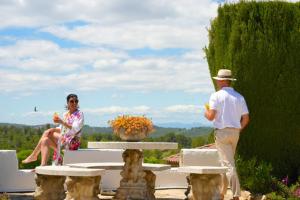 a man and a woman sitting on a bench at Mas Boronat Resort in Salomó