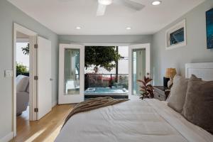 a bedroom with a large bed and a bath tub at Summerland SeaSpa Retreat | The Chosen Collection in Summerland
