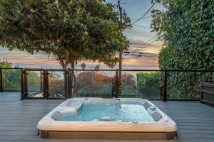 a hot tub on the deck of a house at Summerland SeaSpa Retreat | The Chosen Collection in Summerland
