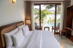a bedroom with a white bed with a view of a pool at Still Reef in Matara +67 photos