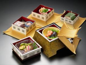 four boxes with different types of food in them at Tabist Yuasa Castle Onsen Hotel in Yuasa