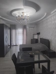 a living room with a bed and a chandelier at Bagrationi 54 in Kobuleti