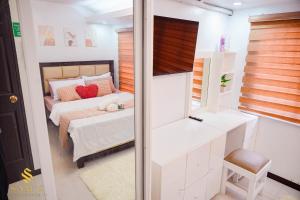 a small bedroom with a bed and a window at Sam's Residence in Marilao +56 photos