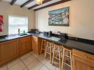 a kitchen with a counter top and a sink at Bacchus Cottage - Uk51964 in Sutton on Sea