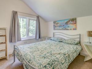 a bedroom with a bed and a window at Thistle Cottage in Ryde