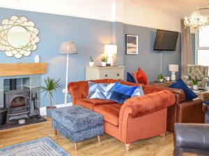 a living room with a couch and a fire place at Bay View - Uk52077 in Criccieth