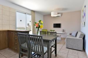 a kitchen and living room with a table and chairs at Makronisos Village in Ayia Napa