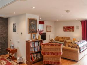 a living room with a couch and a table at The Quarry Stables in Cheddar