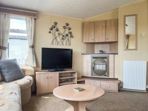 a living room with a couch and a television at Valley View - Uk52130 in Oakmere